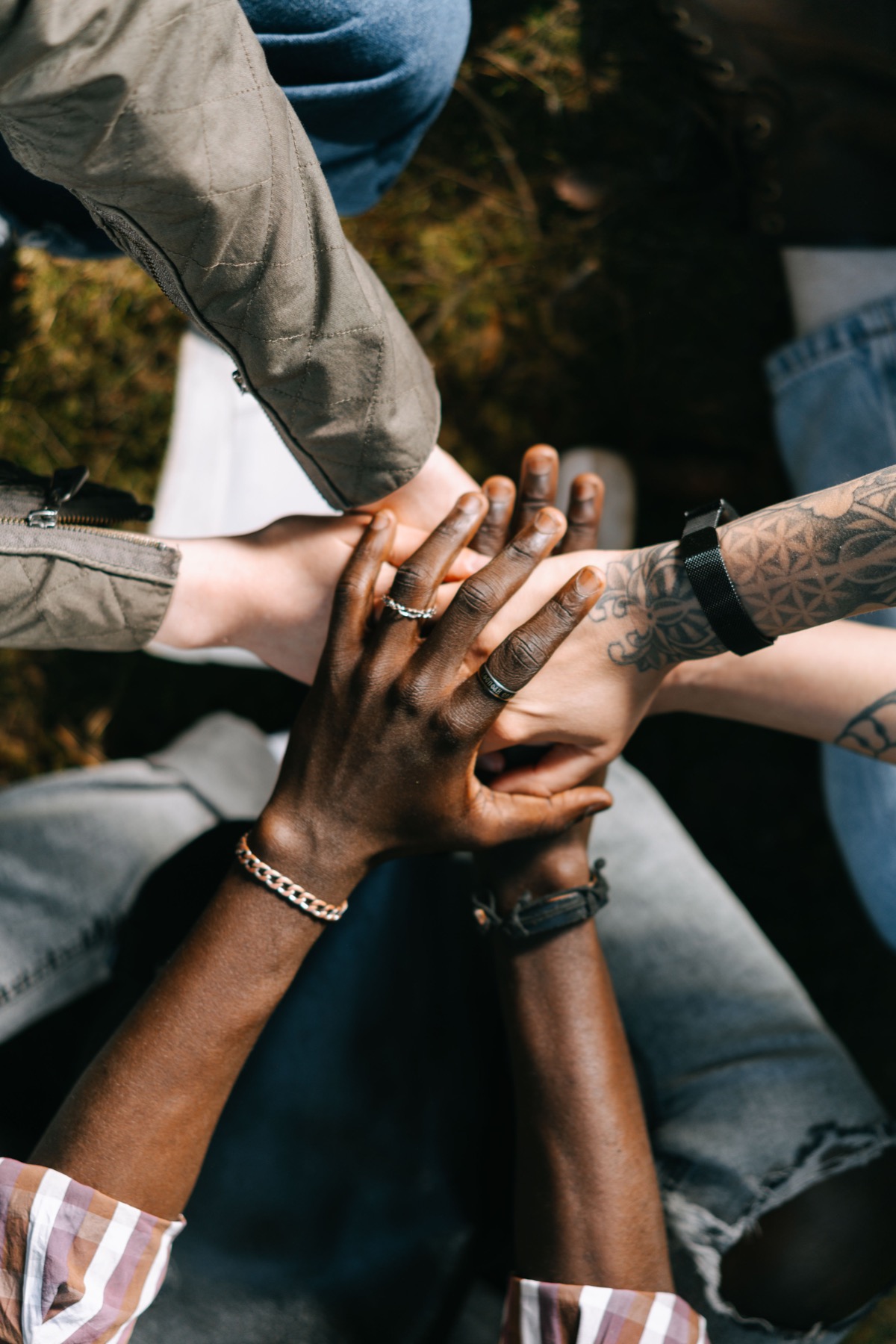 A group stacking hands together outdoors