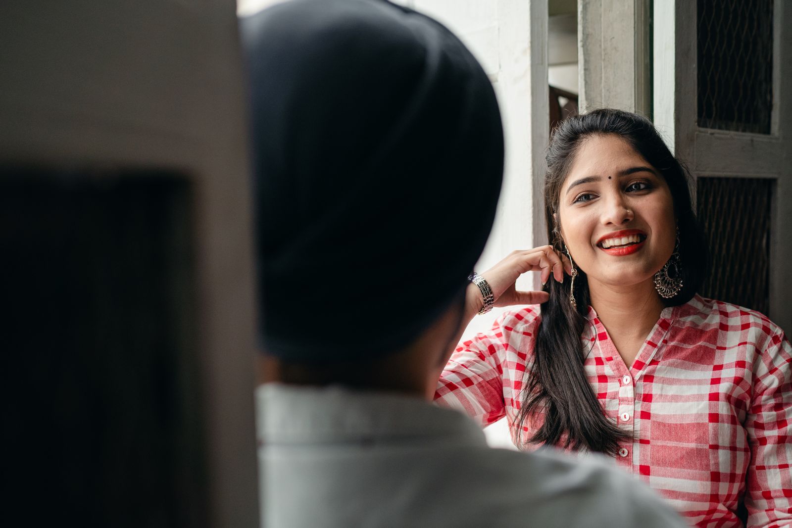 Two adults smiling during a conversation