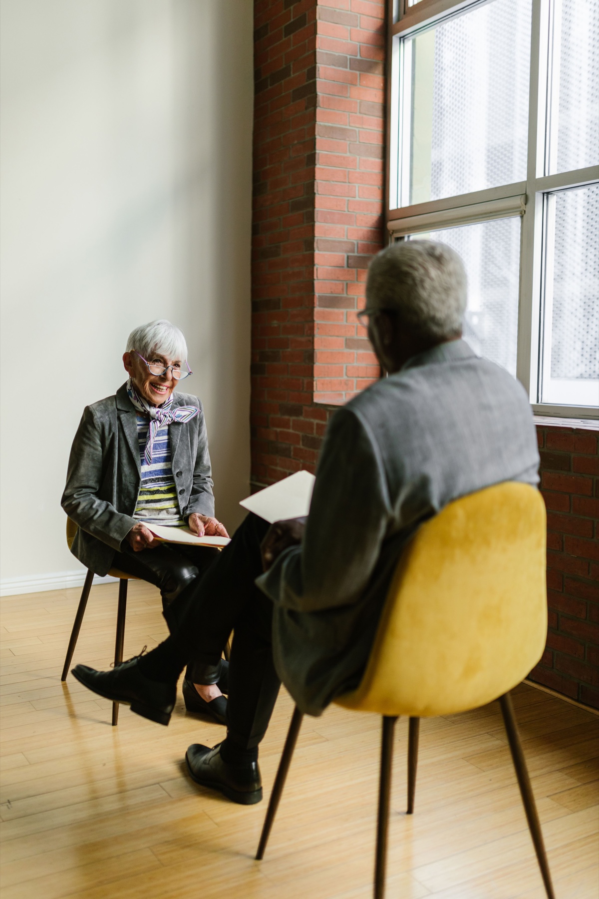 Two adults discussing notes during a one-on-one appointment